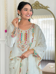 White embroidered kurta set with green clutch
